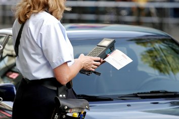 A penalty notice is issued to a parking offender. 