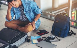 A young man is looking for his passport