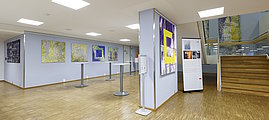 View of the lower Festsaal foyer, several works by Jan Samec and info roll-up