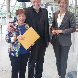 Auf dem Bild sind zwei Frauen und ein Mann zu sehen.